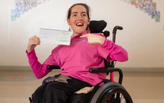 Women holding a donation check.