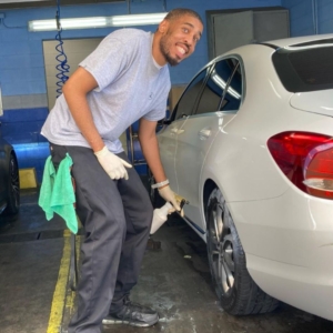 young person cleaning a car
