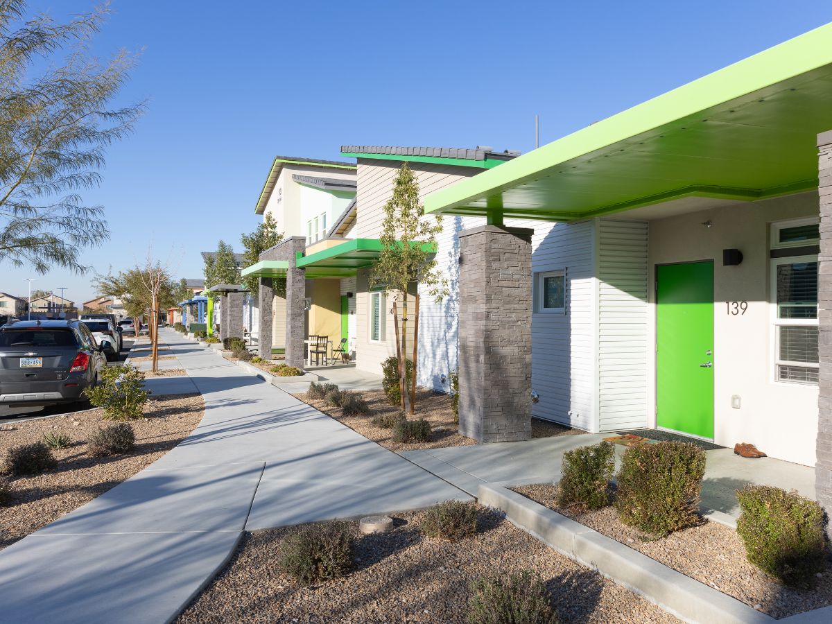 row of townhomes painted white and green