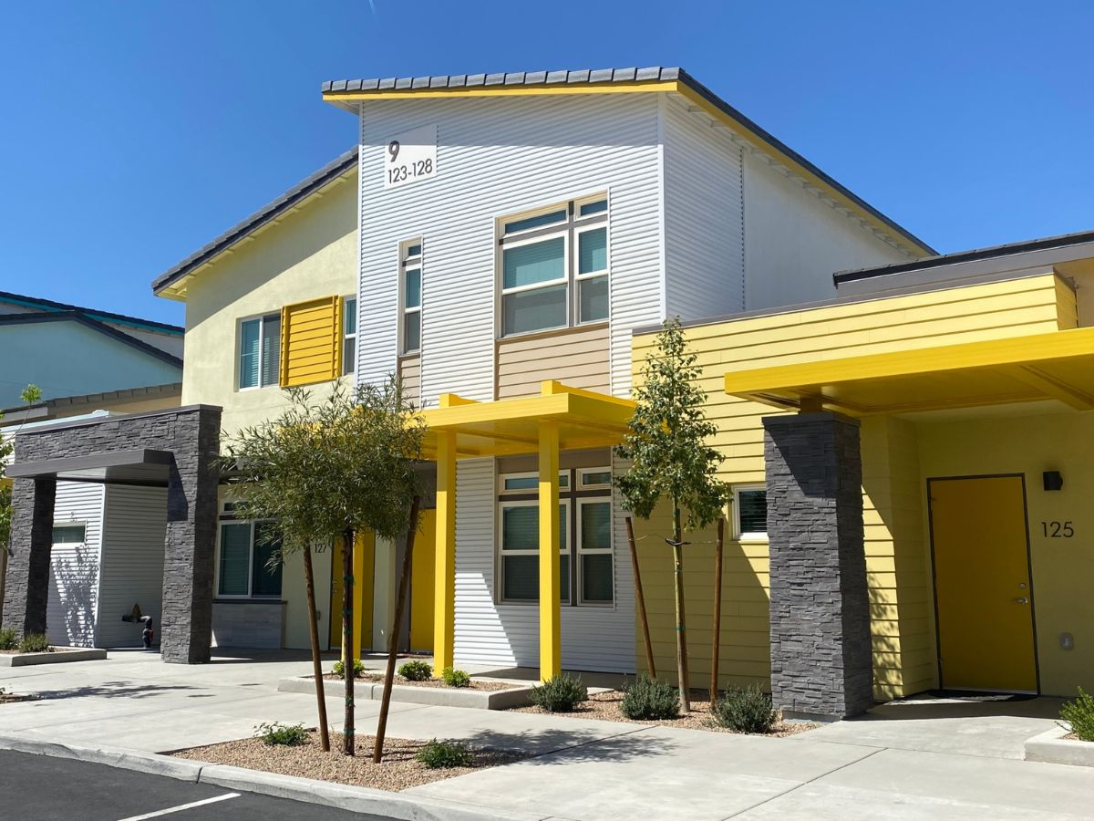 2-story townhome painted white and yellow