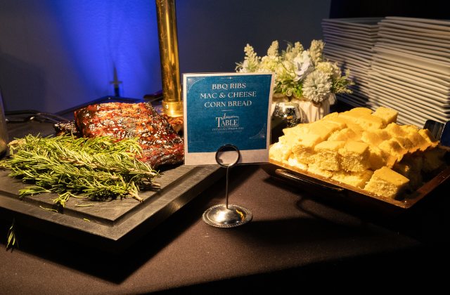 catered food on plates with a place card naming the dishes