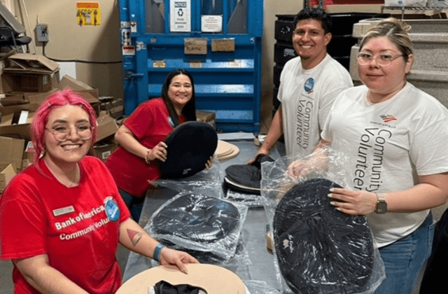 four people volunteering by stuffing bags