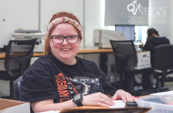 person sitting at a desk sorting folders