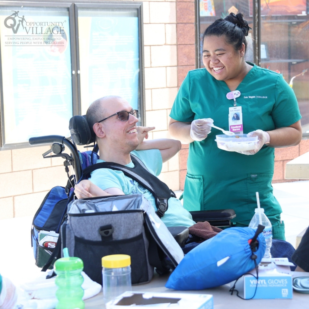 Nurse helping a person in a wheel chair with eating