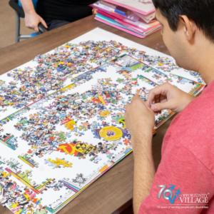 person piecing together a puzzle