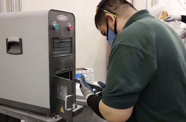 person holding a hard drive that will be shredded