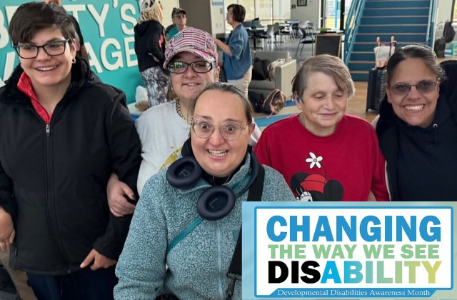 group of five people standing together in a building, the text 'changing the way we see disability, developmental disabilities awareness month', inset in the image